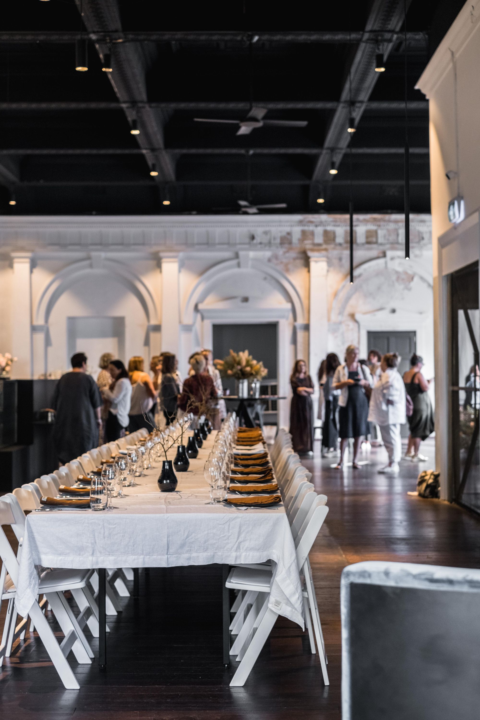 A long candle-lit table set for a private dinner